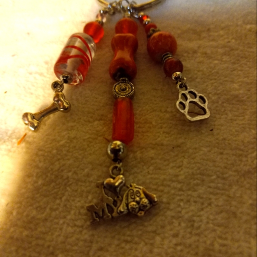 New,handmade 3 strand hanging dog charms keychain. Glass orange &silver beads.